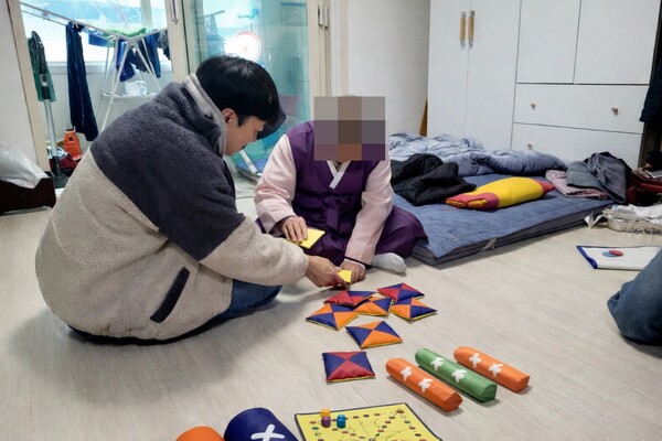 ▲ 치매 어르신과 후견인이 딱지치기 등 전통놀이를 체험하고 있다.